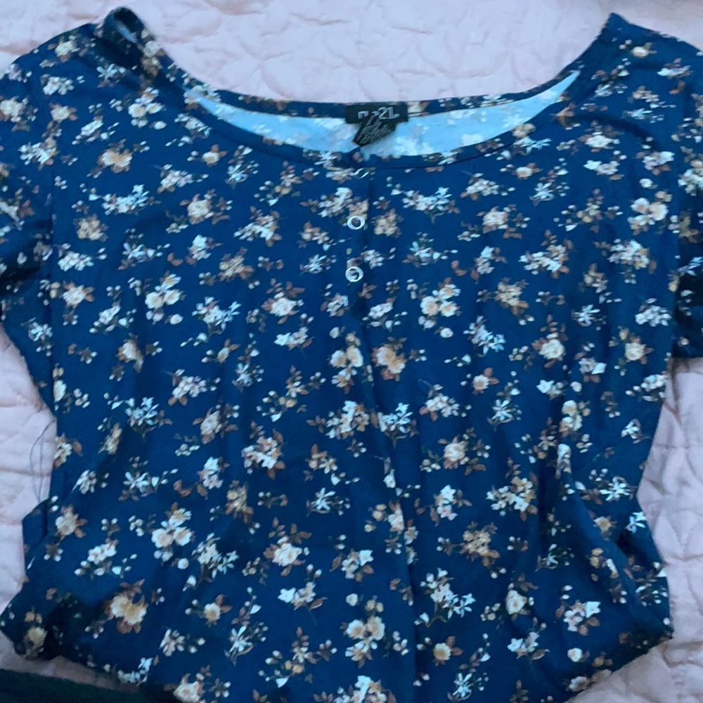 A blue T-shirt with three buttons at the top